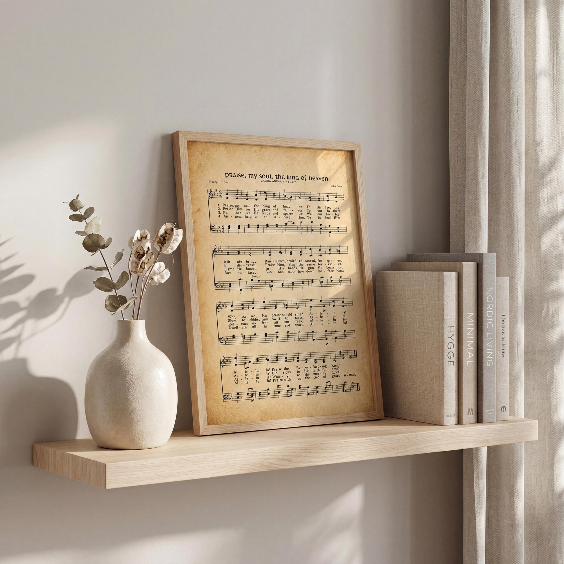 a framed sheet music print of a hymn, placed on a shelf next to a vase with flowers and a stack of books.