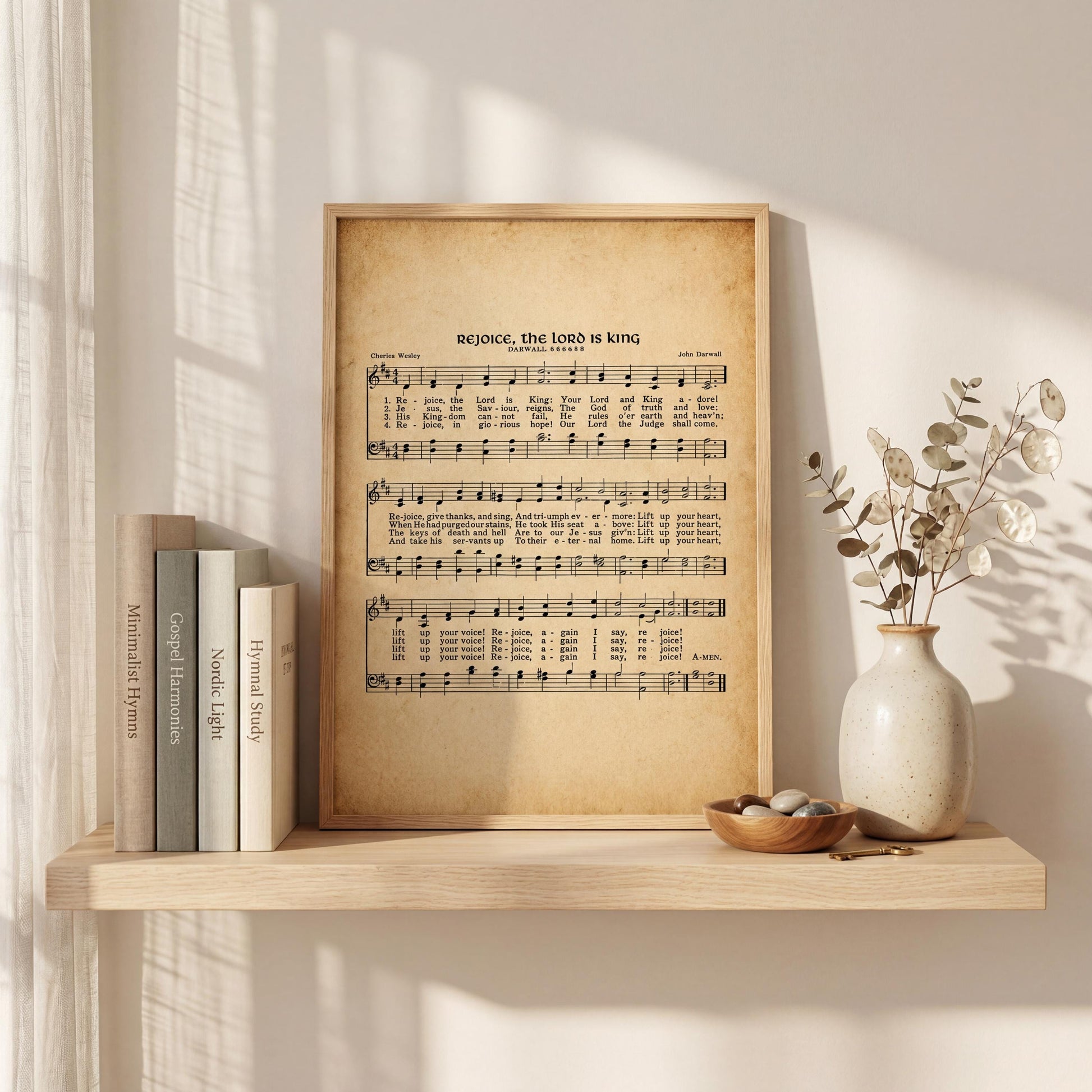 a wooden shelf displaying a framed sheet music of "Revelation, the Lord is King" with a vase of dried flowers and a stack of books on the shelf.