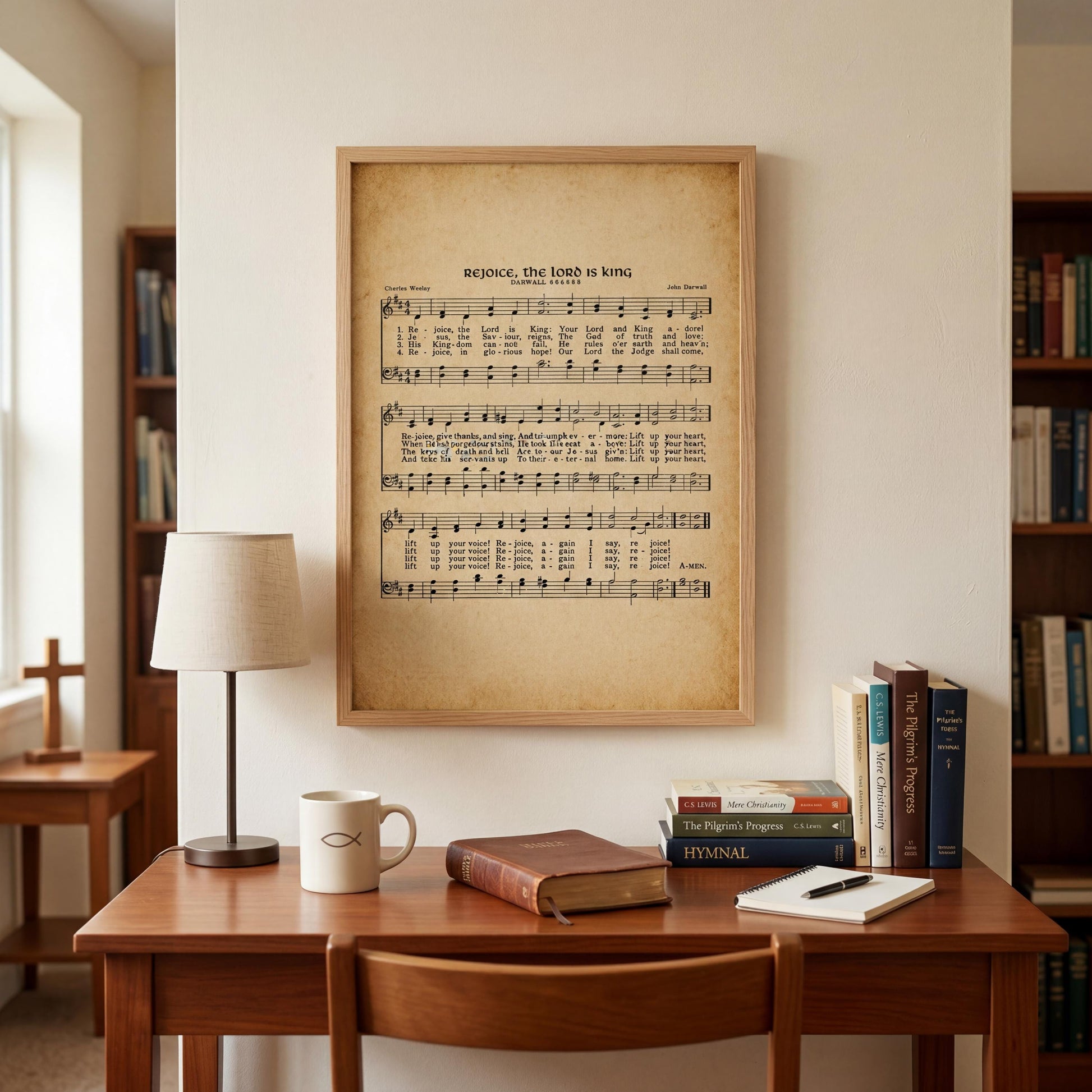 a wooden desk with a lamp, a coffee mug, a stack of books, and a framed sheet music poster on the wall above it.
