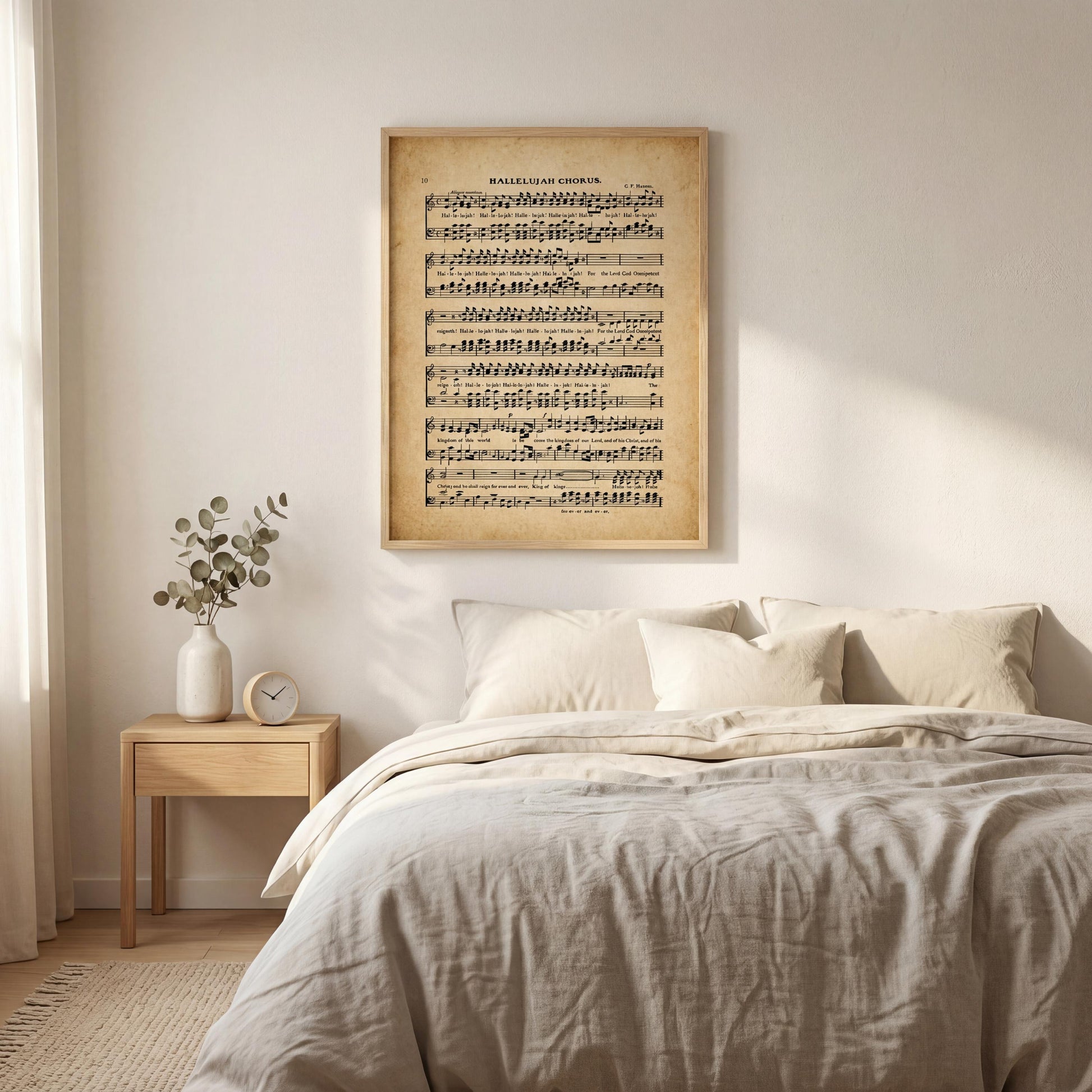 a bedroom setting with a bed, a nightstand, and a framed sheet music poster on the wall above the bed.