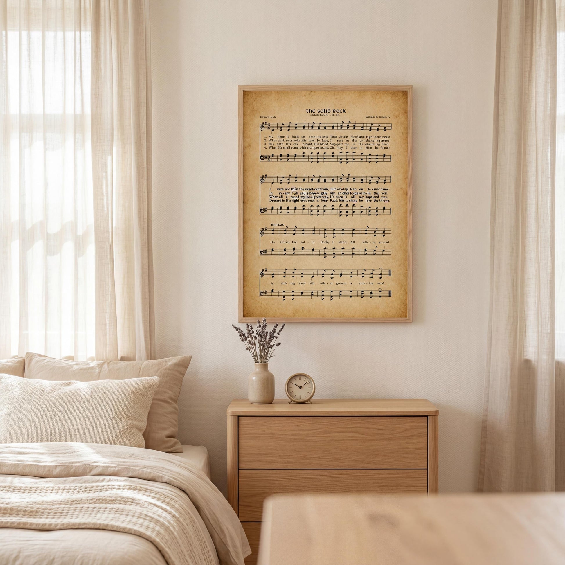 a bedroom with a bed, a dresser, and a framed sheet music poster on the wall.