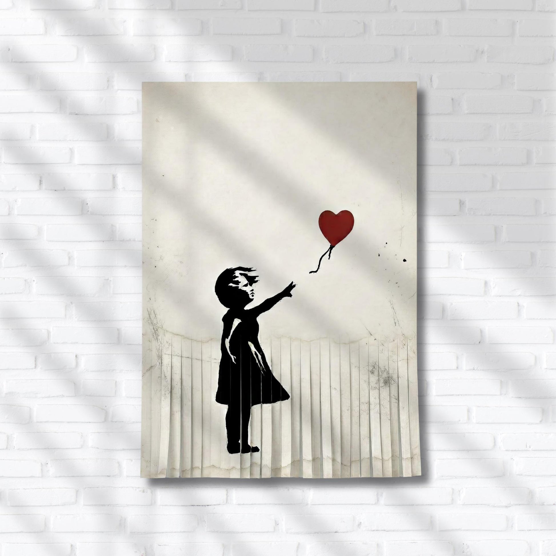 A black and white silhouette of a young girl holding a heart-shaped balloon against a white brick wall background.