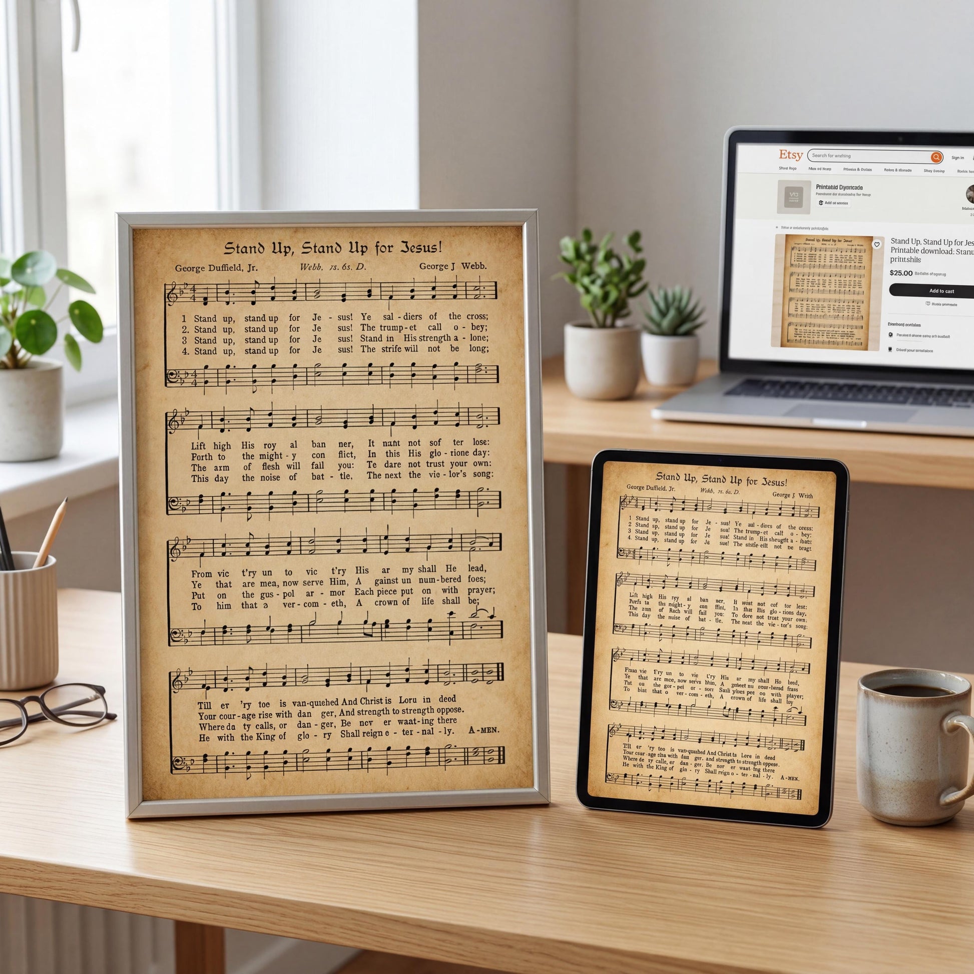 a framed sheet of music titled "Stand Up, Stand Up for Jesus!" with sheet music and lyrics, placed on a desk next to a laptop and a mug.