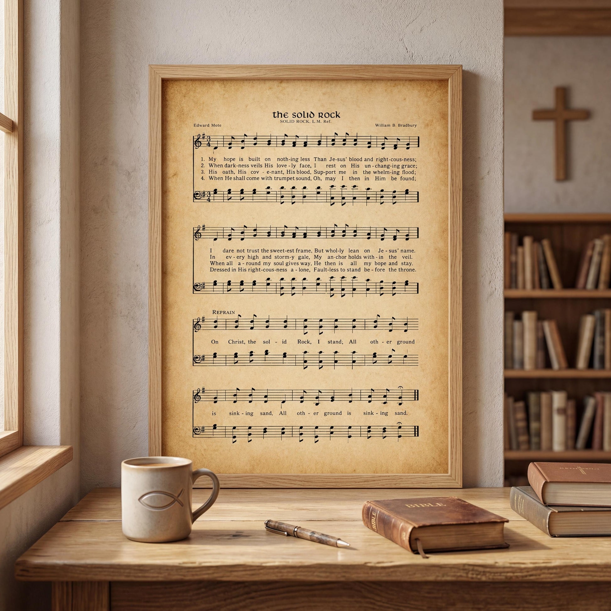 a framed sheet music poster of "The Silver Rock" song lyrics, accompanied by a coffee mug, a pen, and a book on a wooden desk.