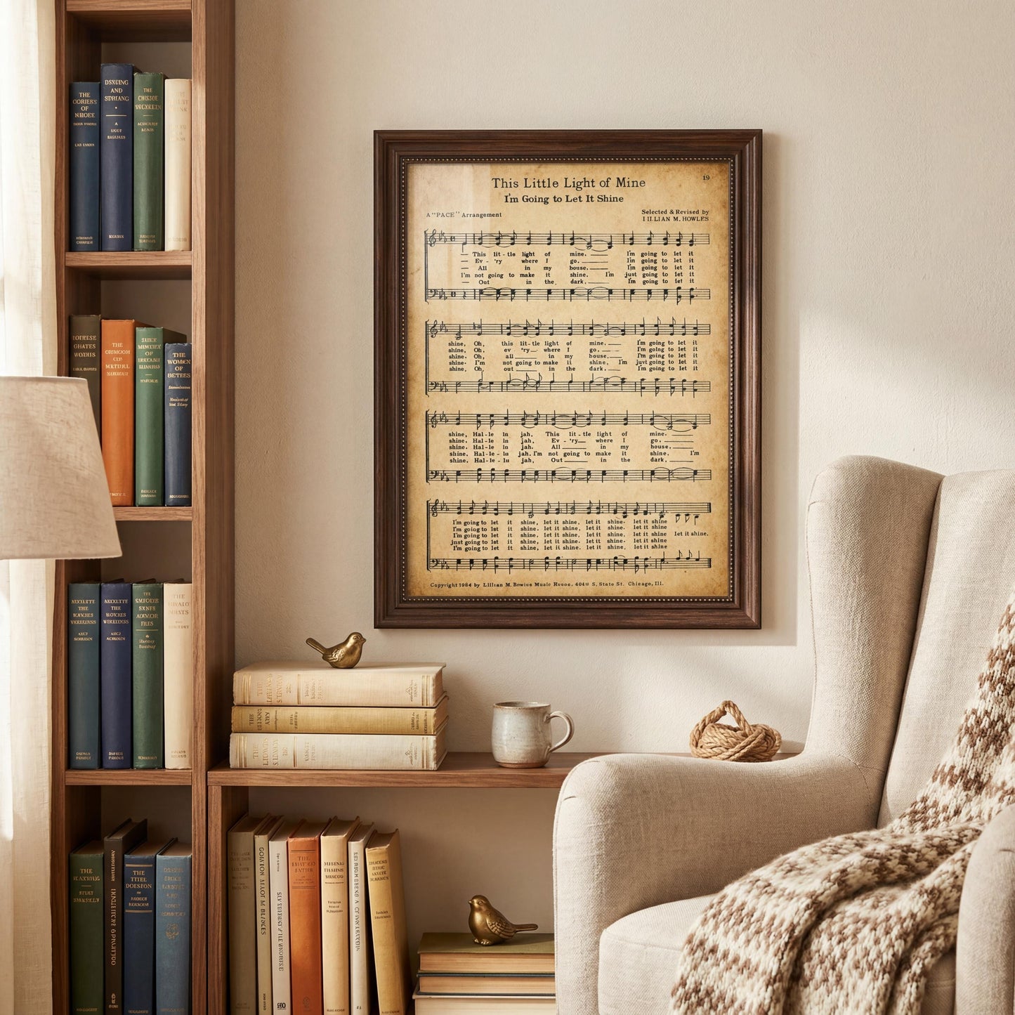 a cozy living room with a bookshelf filled with books, a framed sheet music poster on the wall, and a beige armchair with a throw blanket.