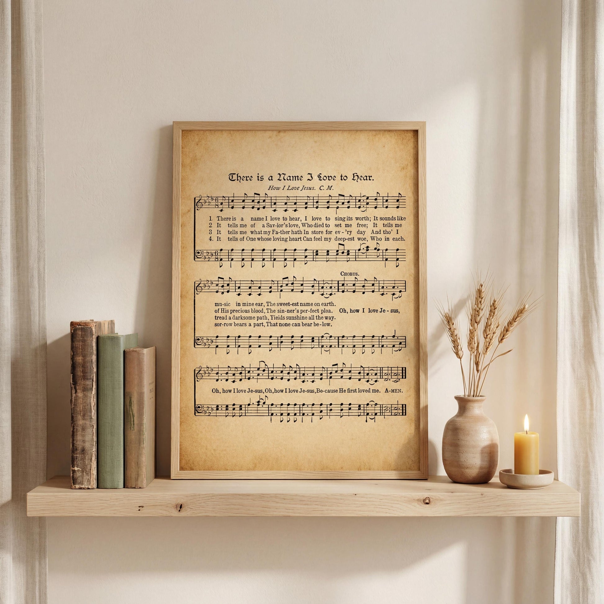a framed sheet music poster with a vintage appearance, placed on a wooden shelf next to a vase with wheat stalks and a lit candle.