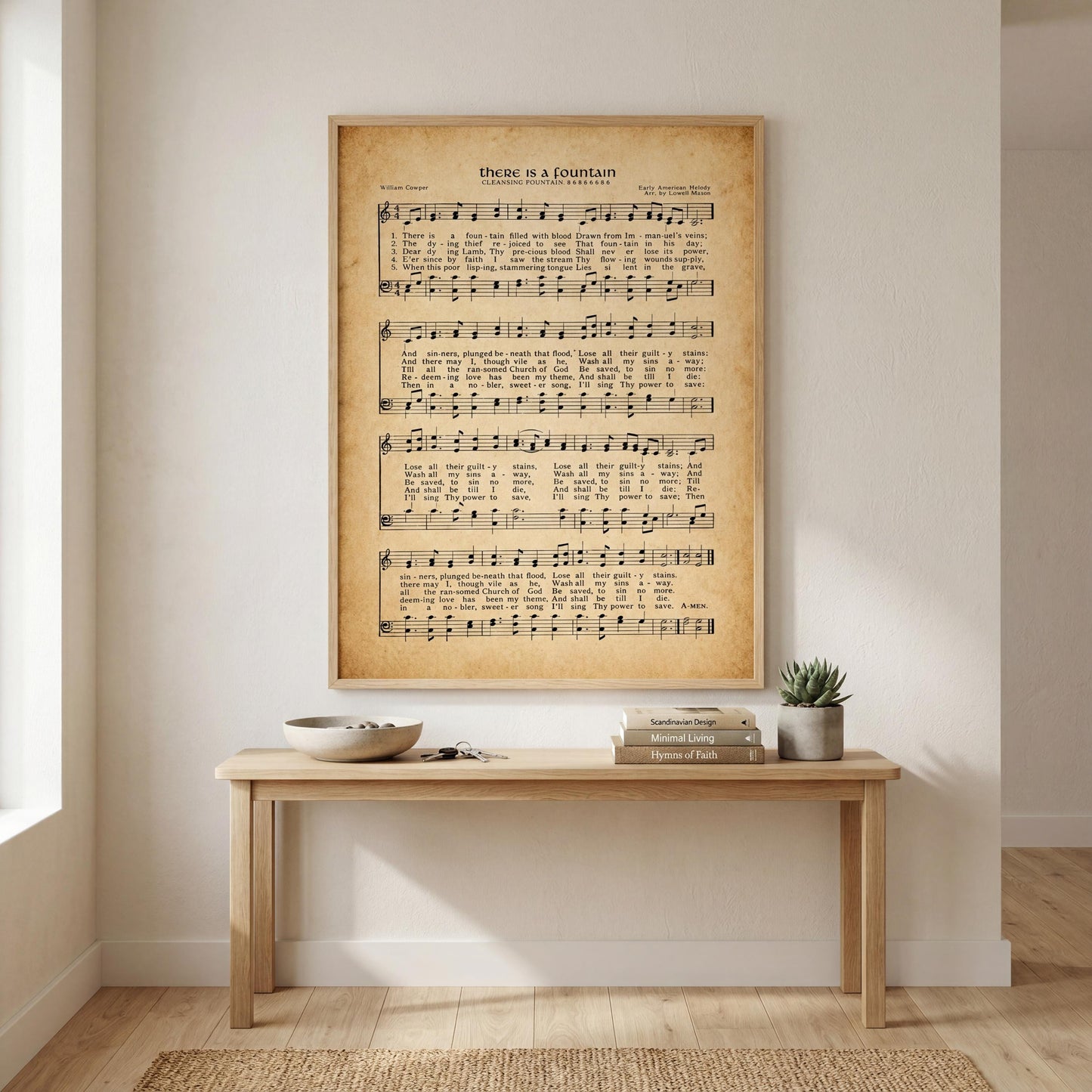 a wooden table with a bowl and a plant on it, and a framed sheet of music is hanging on the wall above the table.