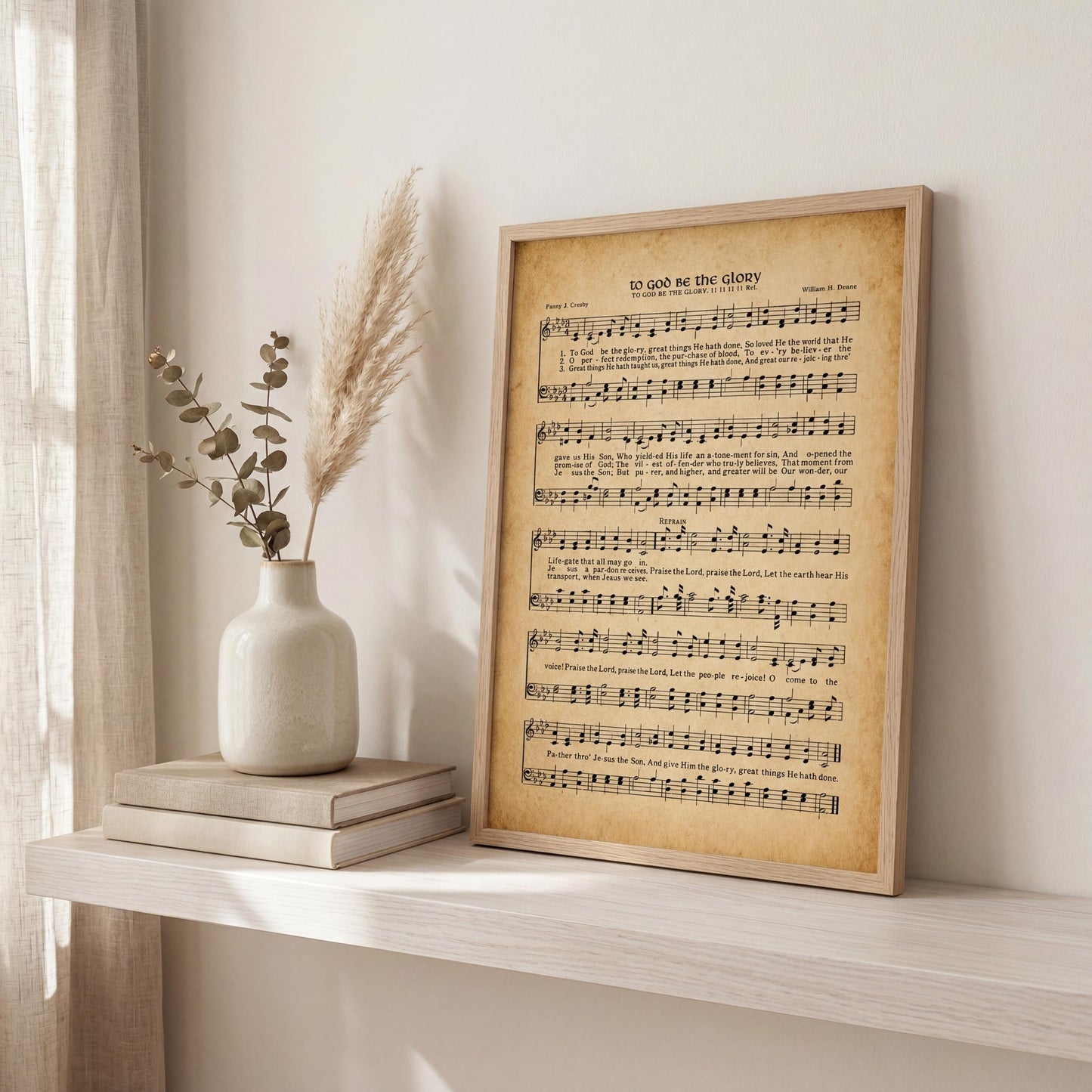 a framed sheet music print titled "To Go on the Glory" displayed on a shelf next to a vase with greenery and a stack of books.