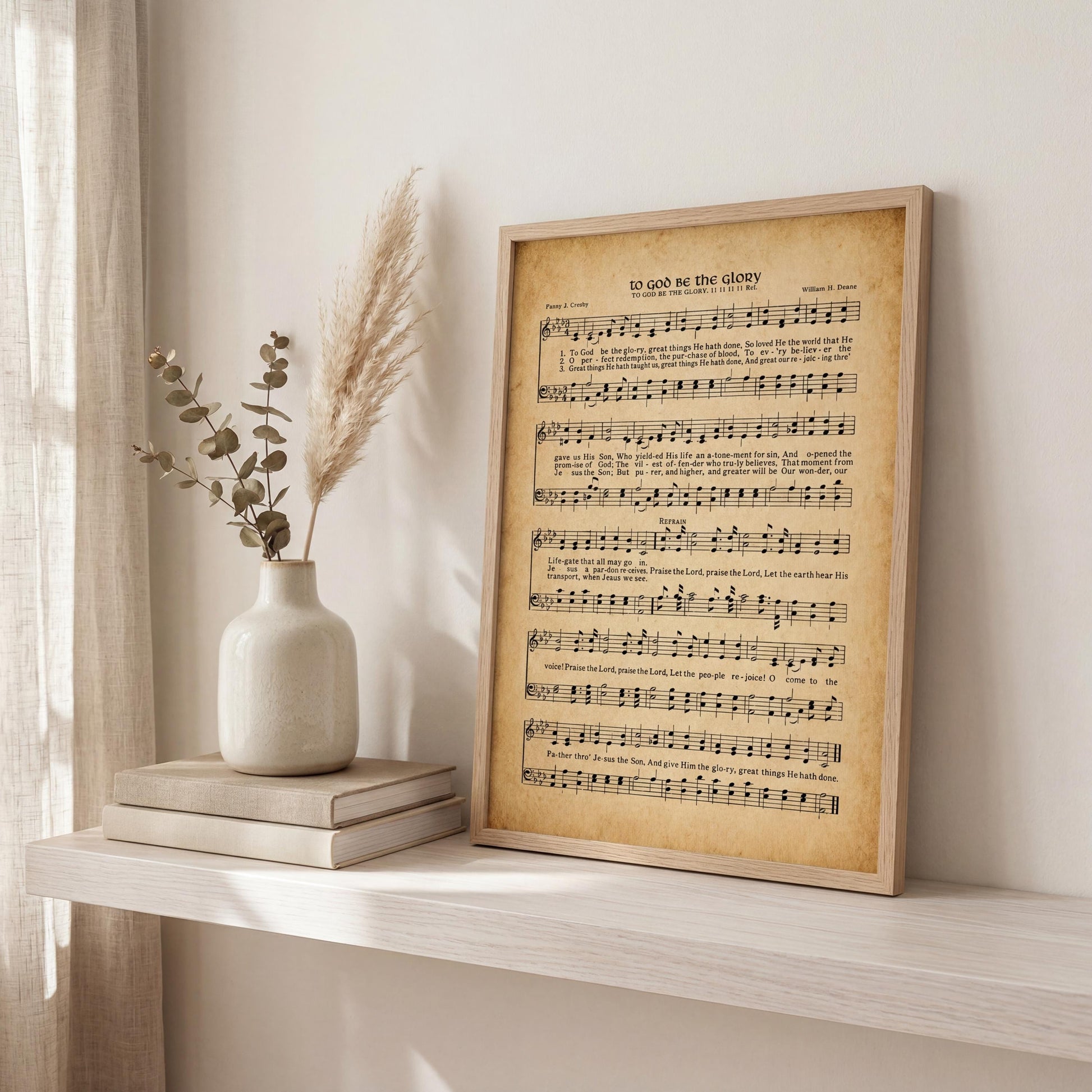 a framed sheet music print titled "To Go on the Glory" displayed on a shelf next to a vase with greenery and a stack of books.