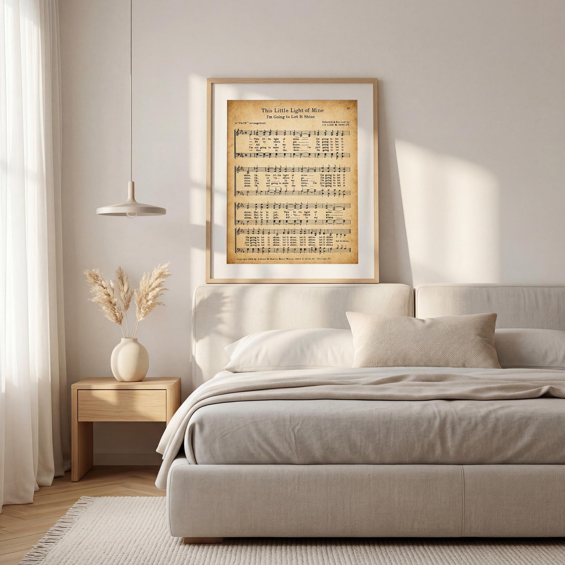a bedroom with a bed, a nightstand, and a framed sheet music poster on the wall.