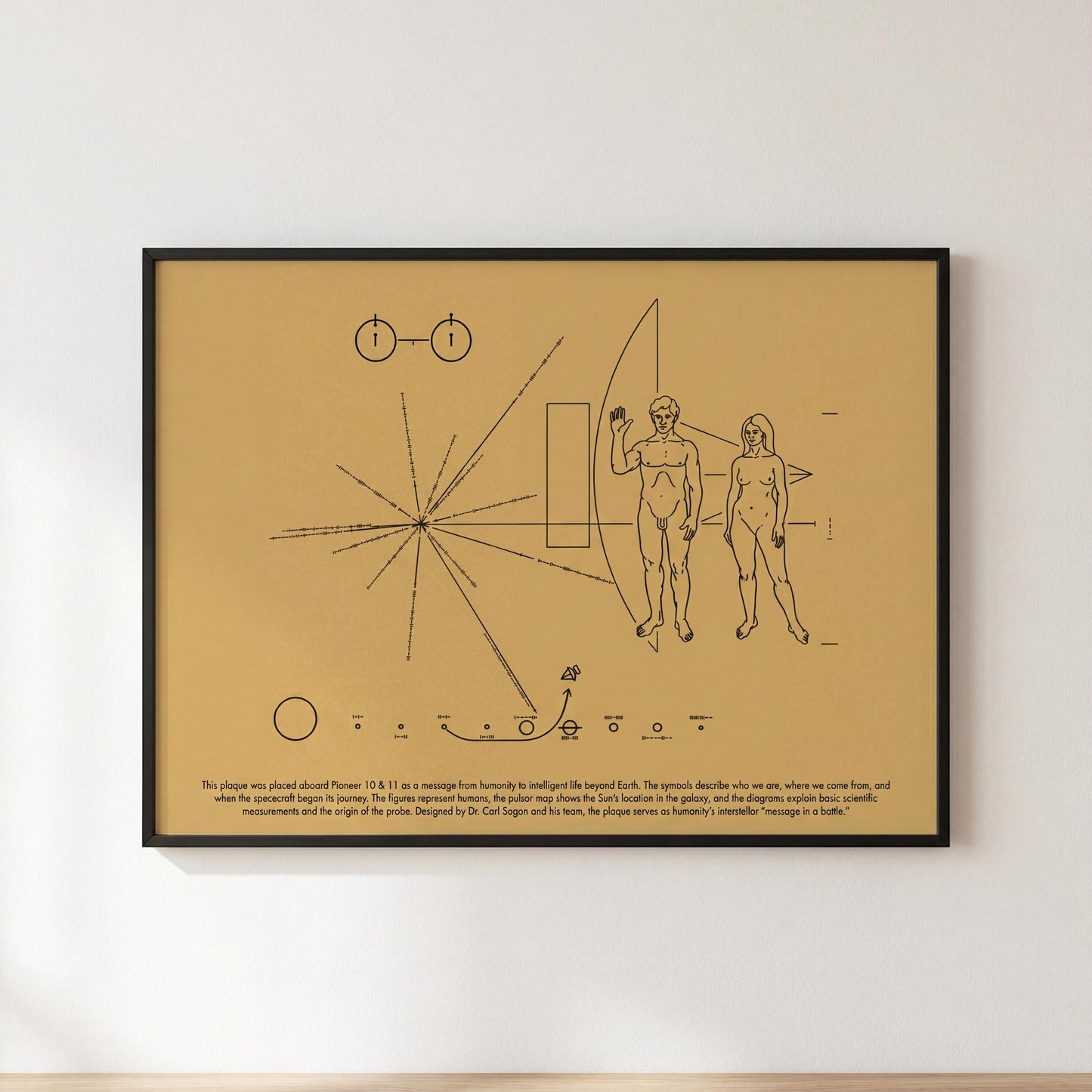 The image is a framed print featuring a black and white illustration of a spacecraft with two figures, one male and one female, along with various geometric shapes and symbols.