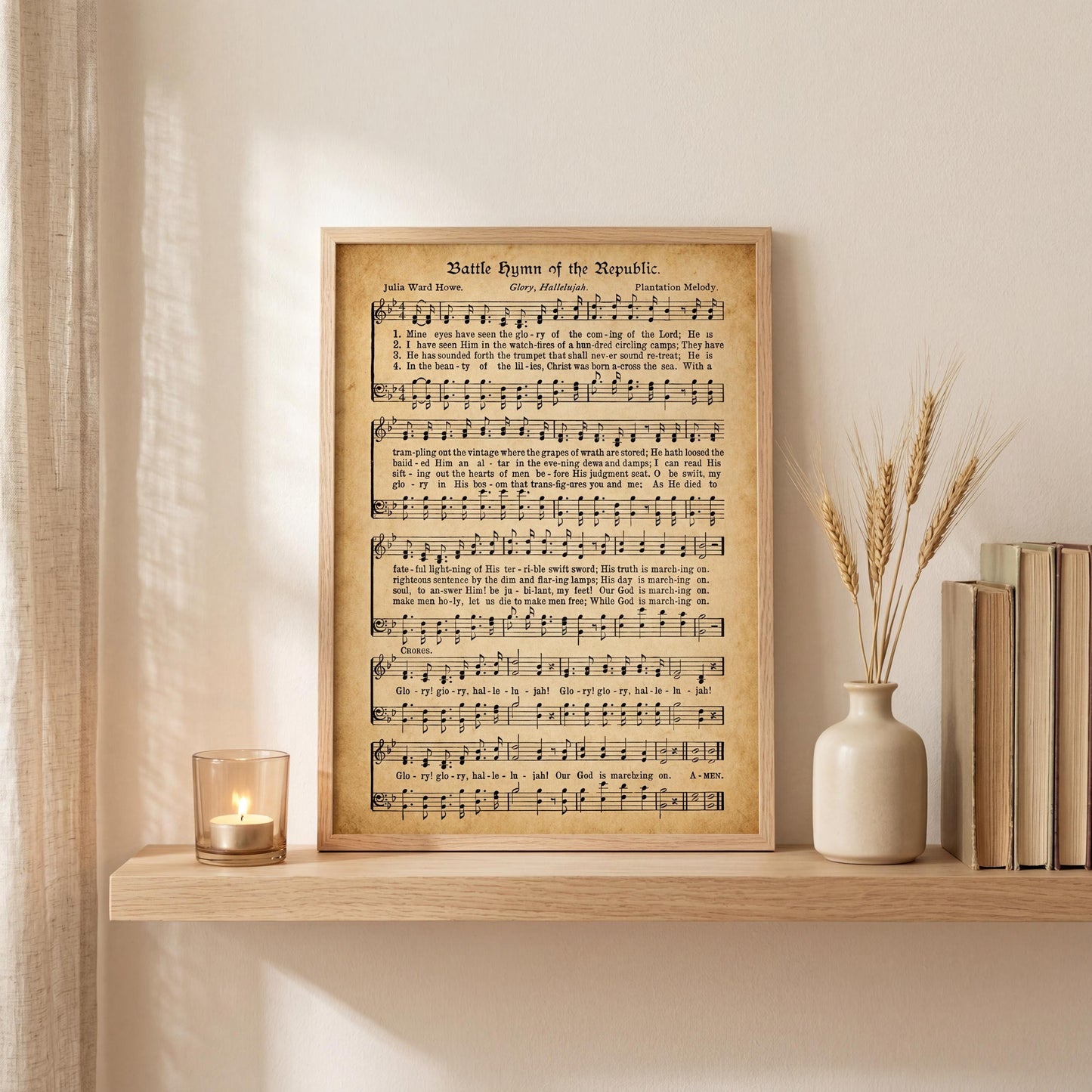 a framed sheet music titled "Battle Hymn of the Republic" with a candle and a vase of wheat stalks on a shelf.