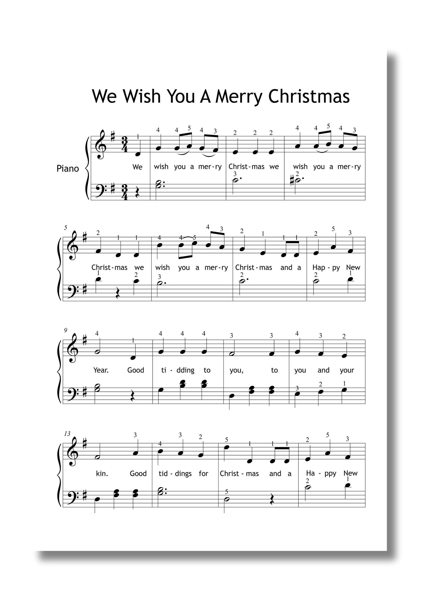 Printed We Wish You a Merry Christmas simplified piano score beside music book and hot cocoa, Christmas edition PDF for seasonal performances.
