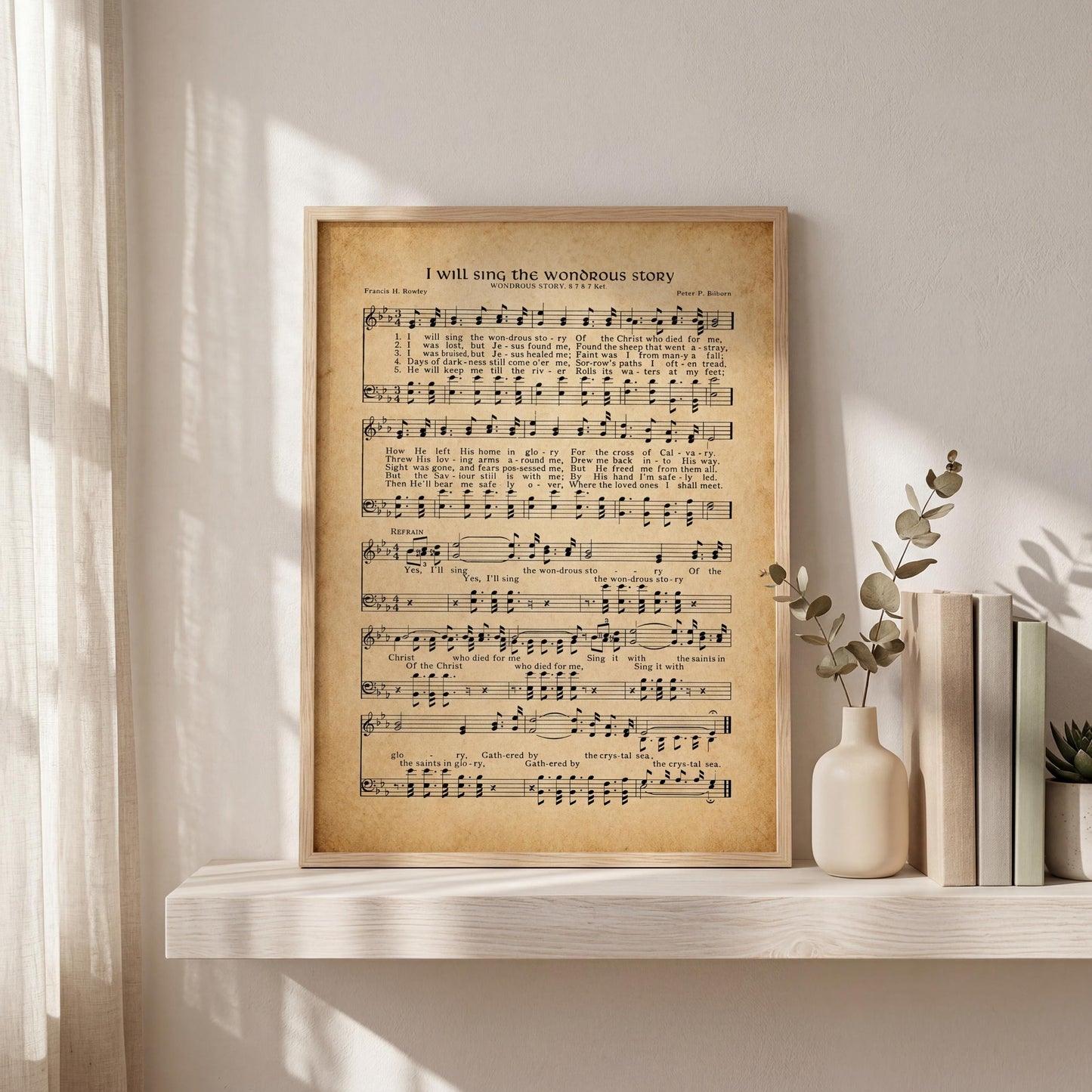 a framed sheet music poster of a hymn titled "I will sing the wonderful story" displayed on a shelf next to a vase with plants and some books.