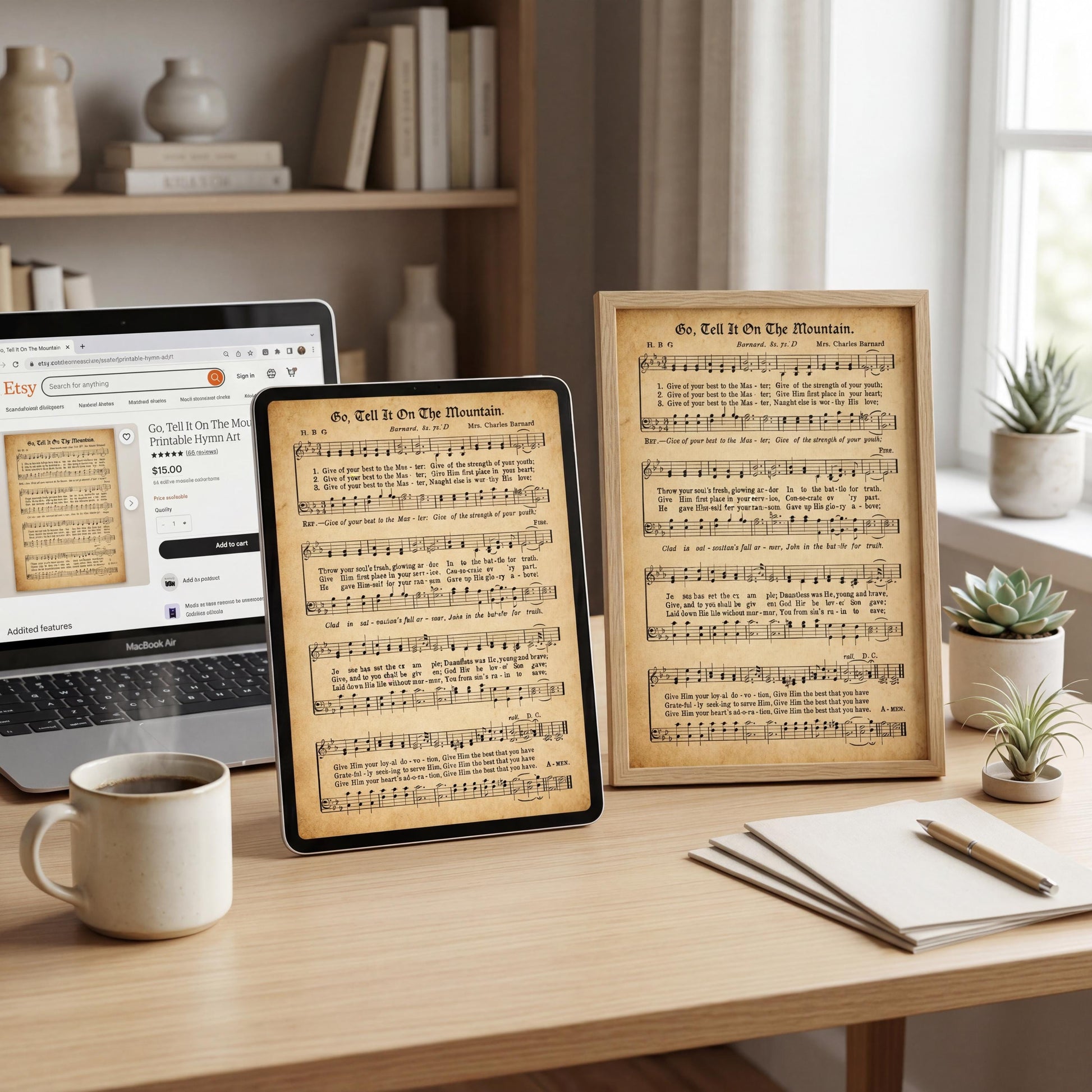a wooden desk with a laptop, a framed sheet of music, a coffee mug, and some plants.